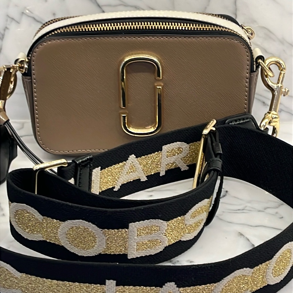 Marc Jacob’s tan, black, and cream leather crossbody